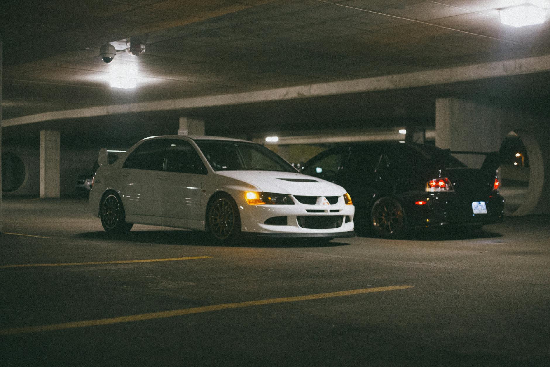 white and black sedan car parked in a lot