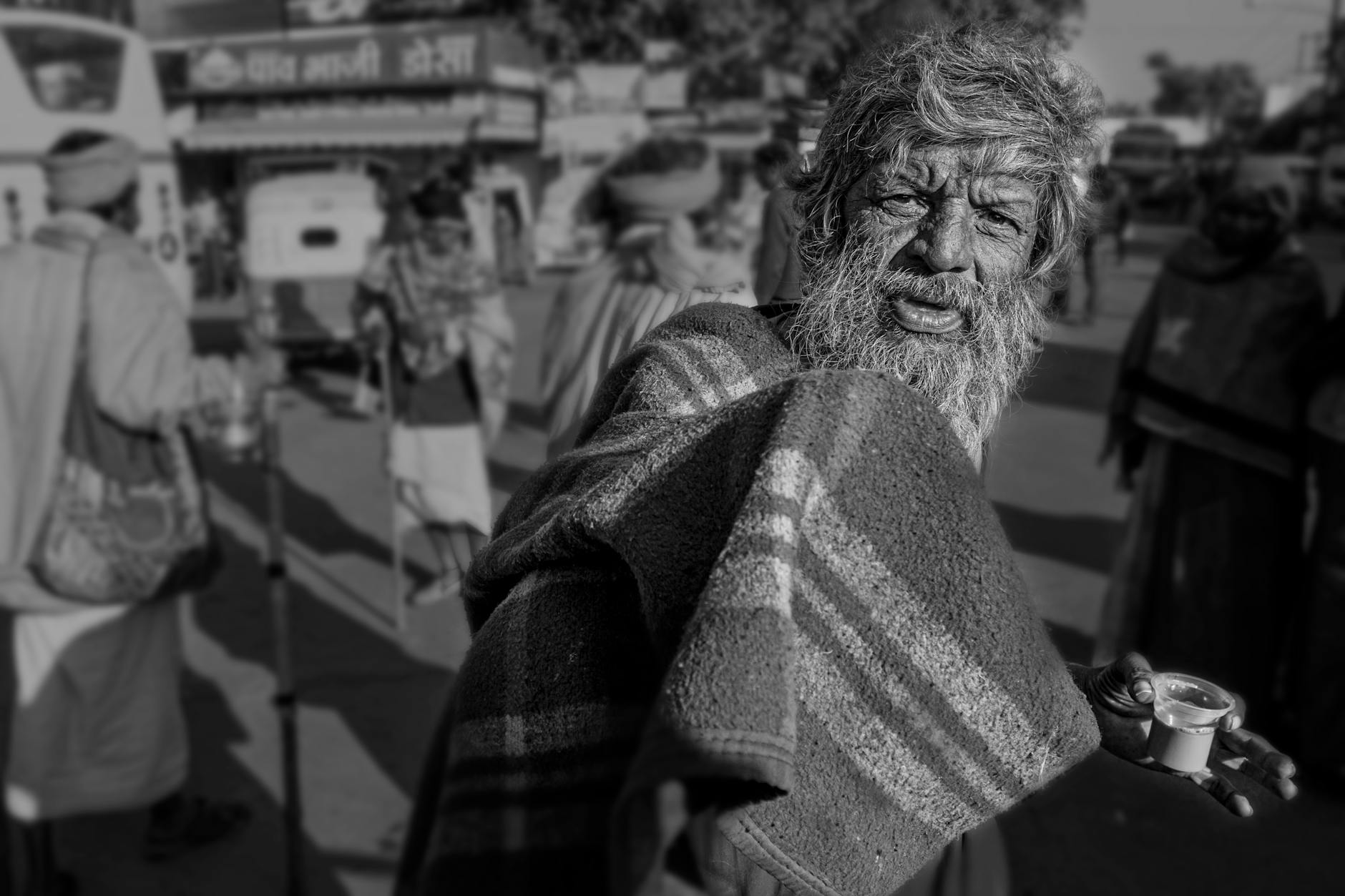 elderly man on a street in india in black and white